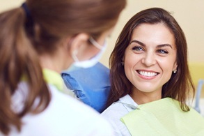 Female patient smiling after receiving dental crown in Salinas, CA