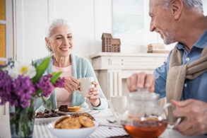 Older couple with dental implants in Salinas eating together