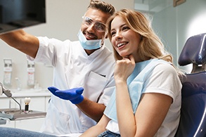 Dentist explaining cost of dental implants in Salinas to patient