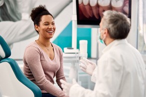 Woman smiling at dentist during consultation