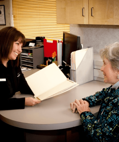 member of dental staff smiling with patient