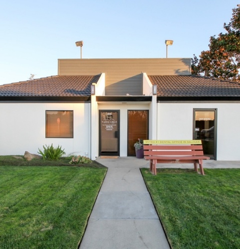 smiling staff member handing patient paperwork in Santa Clarita