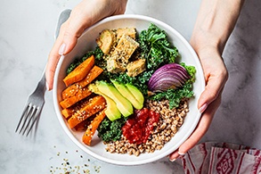 Patient holding bowl filled with nutrient-dense foods