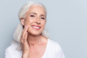 Older woman with an implant-retained denture.