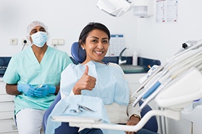 Woman gives thumbs up while visiting Salinas dentist 