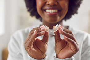 a woman holding a teeth whitening tray