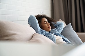 Woman resting at home after wisdom tooth extraction in Salinas, CA