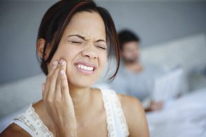 woman experiencing tooth pain