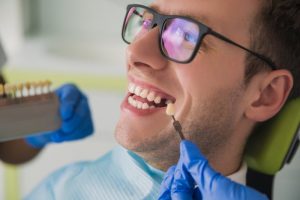 man in dental chair missing tooth preparing for dental crown