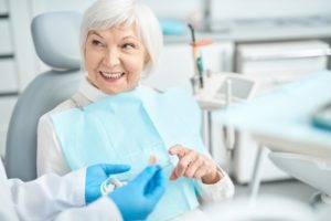 older woman fitted with implant dentures