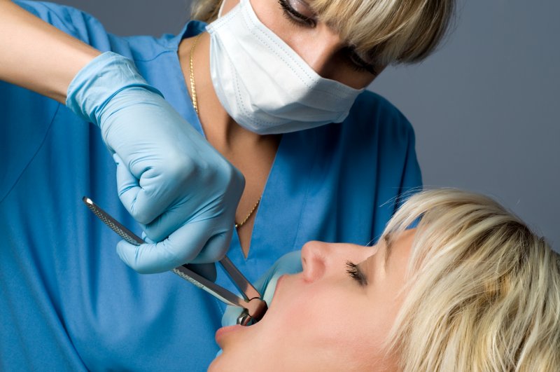 A dentist extracting a tooth