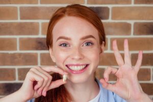 Woman smiling after a wisdom tooth extraction
